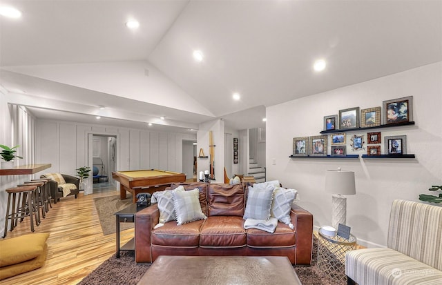 living room featuring light hardwood / wood-style flooring, high vaulted ceiling, and billiards