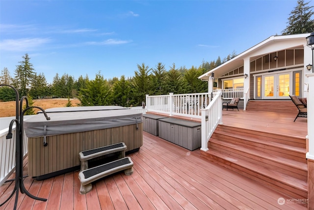 deck with french doors and a hot tub