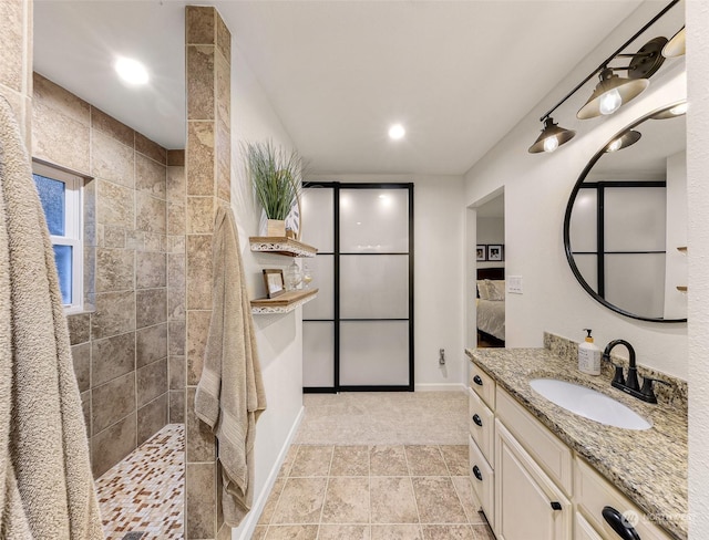 bathroom with vanity and tiled shower