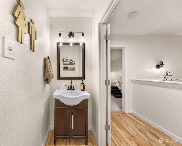 bathroom featuring hardwood / wood-style flooring and vanity