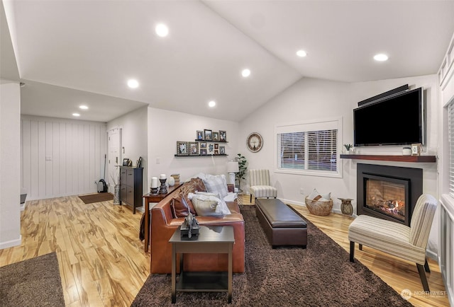 living room featuring hardwood / wood-style flooring and vaulted ceiling