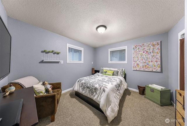 bedroom with carpet floors and a textured ceiling