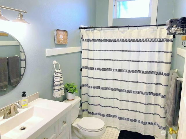 bathroom with vanity, a shower with shower curtain, and toilet