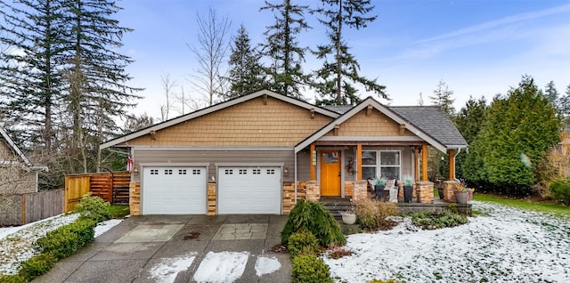 craftsman-style house featuring a porch and a garage