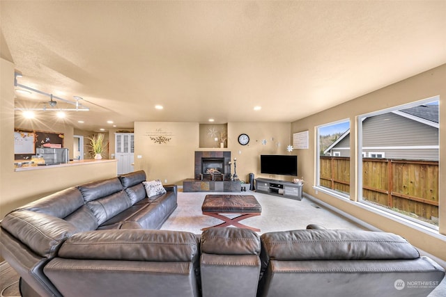 carpeted living room featuring a fireplace