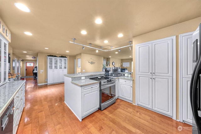 kitchen with stainless steel range with electric stovetop, white cabinets, black fridge with ice dispenser, kitchen peninsula, and light wood-type flooring