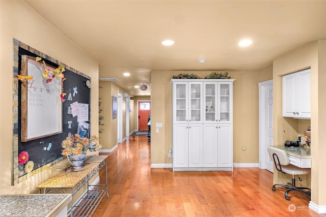 interior space featuring light hardwood / wood-style floors and white cabinets