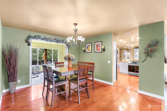 dining room featuring a chandelier and light hardwood / wood-style flooring