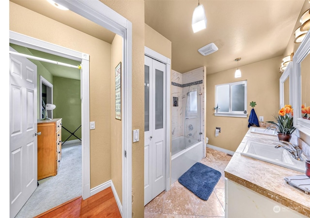 full bathroom with vanity, toilet, and tiled shower / bath combo