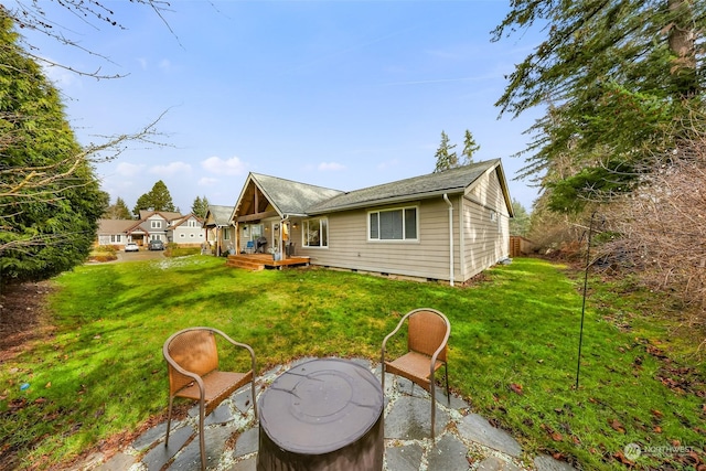 rear view of house featuring a yard and a patio area