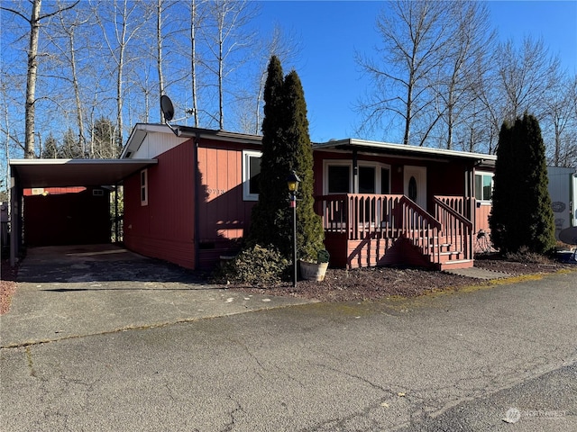 view of front of home with a carport and covered porch