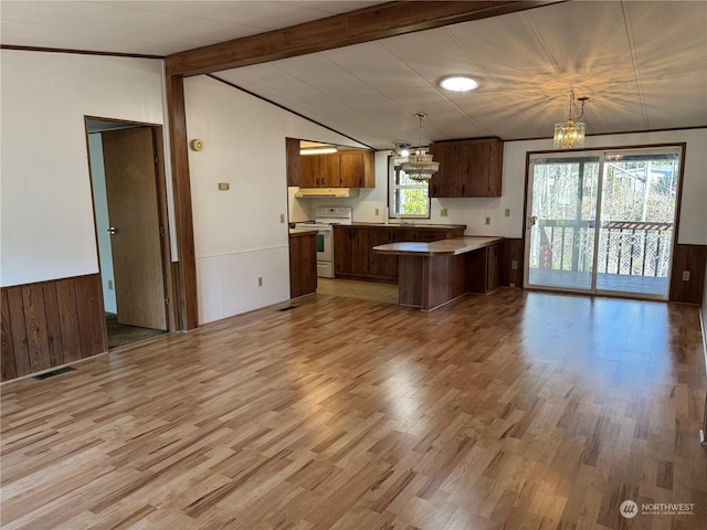 kitchen with vaulted ceiling with beams, decorative light fixtures, a chandelier, white electric stove, and light hardwood / wood-style floors