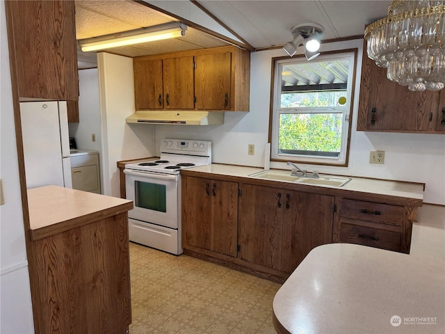 kitchen featuring sink, white appliances, and washer / dryer