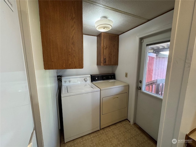 laundry room with cabinets and washer and dryer