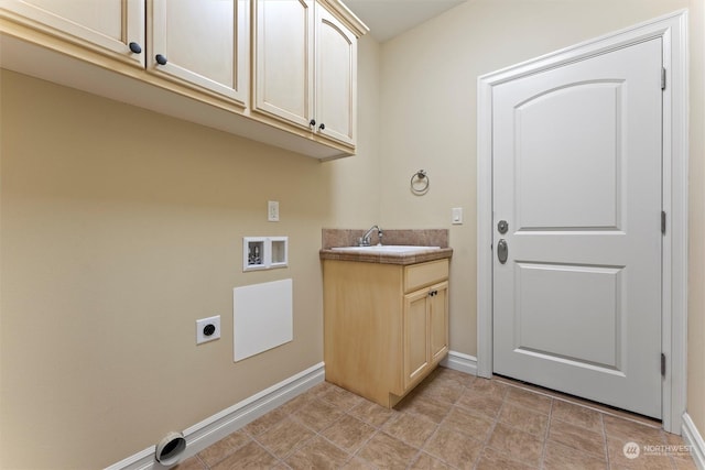 clothes washing area with cabinets, hookup for an electric dryer, hookup for a washing machine, and sink