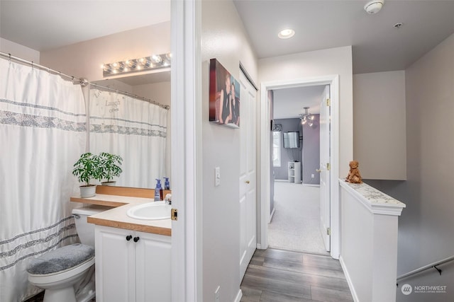 bathroom with vanity, hardwood / wood-style floors, and toilet