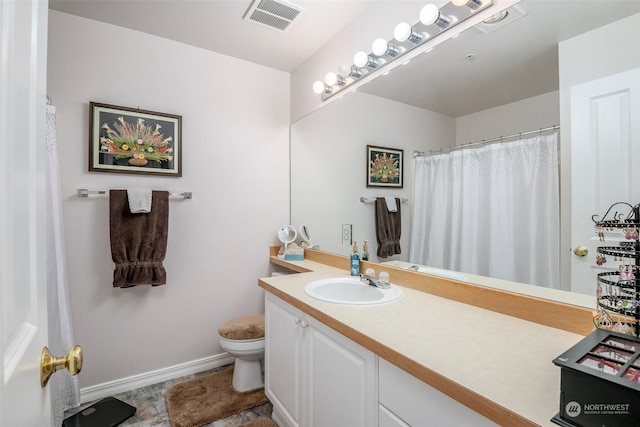 bathroom featuring vanity and toilet