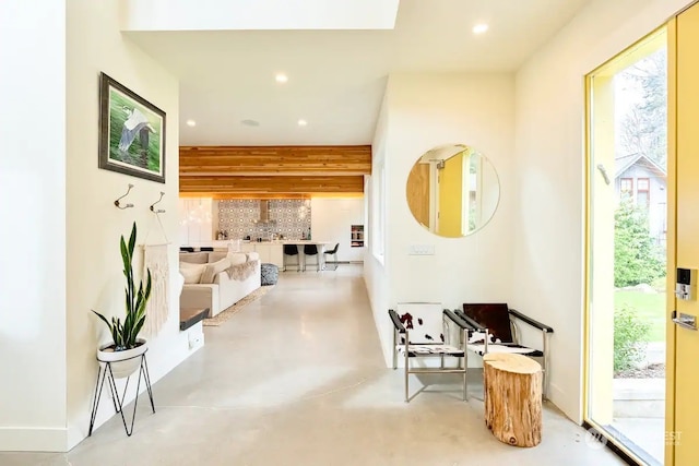 corridor with concrete floors and recessed lighting