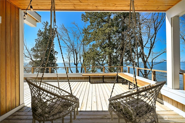 wooden terrace featuring a water view