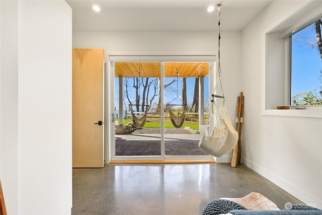 doorway to outside featuring baseboards