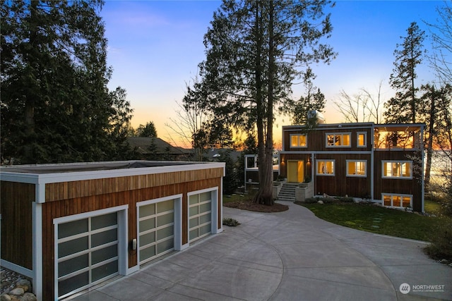 rear view of property featuring an outbuilding