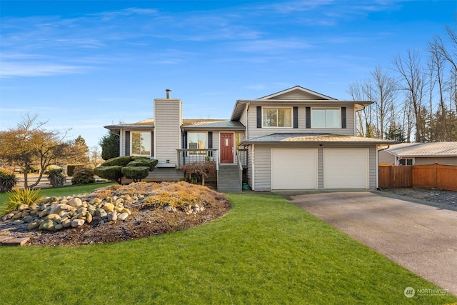 tri-level home featuring a garage and a front lawn