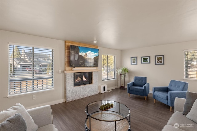 living room featuring a healthy amount of sunlight and dark hardwood / wood-style floors