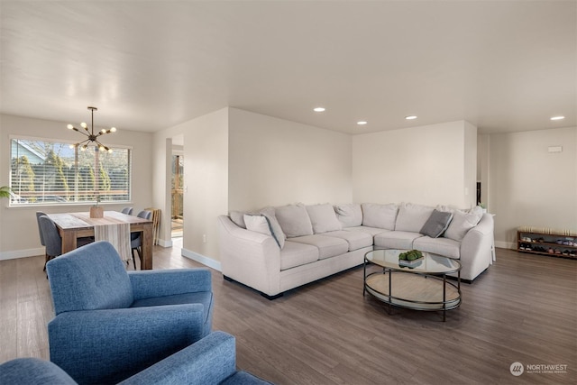 living room with an inviting chandelier and dark wood-type flooring