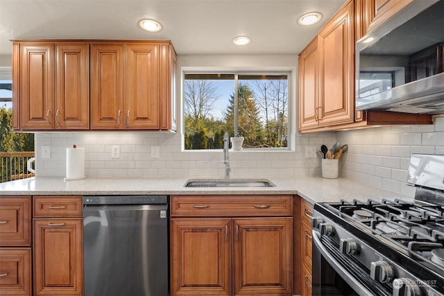 kitchen featuring sink, dishwashing machine, gas stove, and decorative backsplash