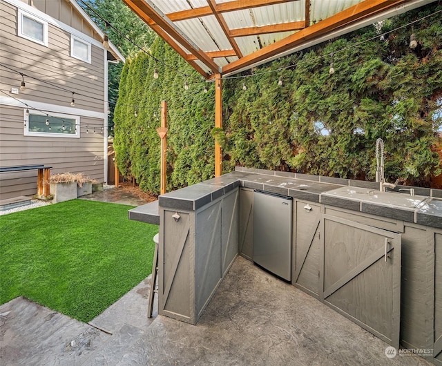 view of patio / terrace with area for grilling and sink