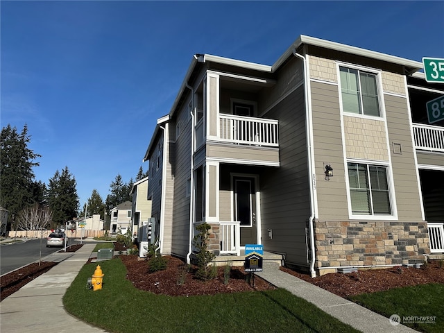 view of home's exterior with a balcony