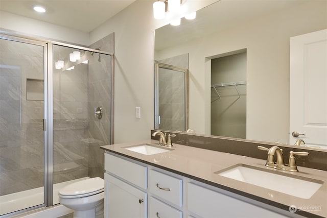 bathroom with vanity, toilet, and walk in shower