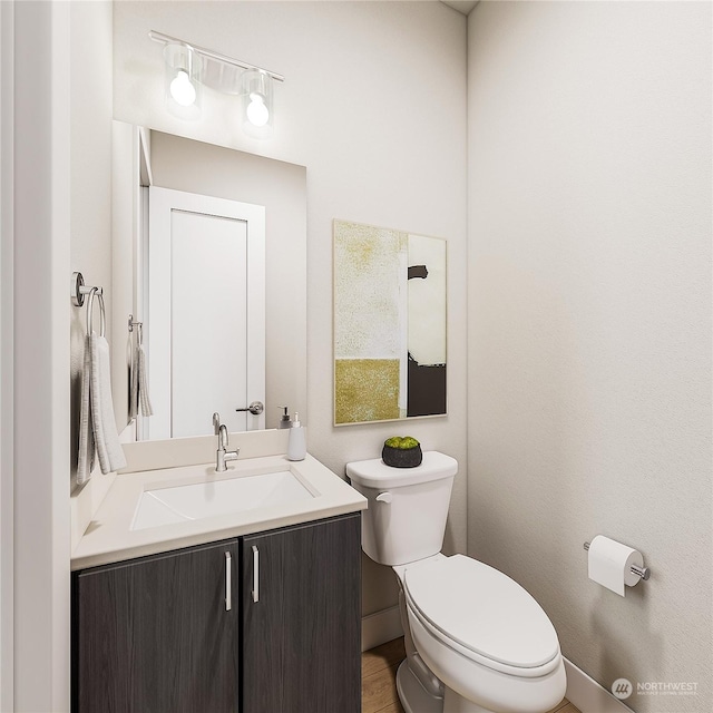 bathroom featuring vanity and toilet