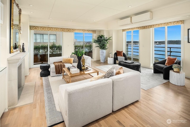 sunroom / solarium with a water view and an AC wall unit