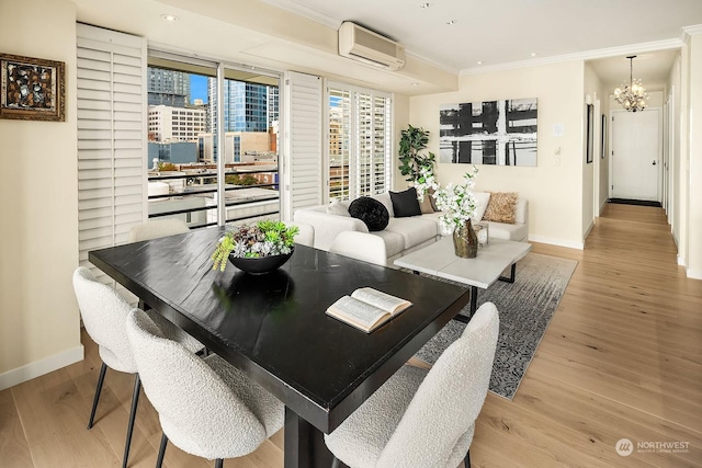 dining area featuring crown molding, light wood-type flooring, a wall mounted air conditioner, and a chandelier