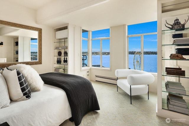 bedroom with a water view, a baseboard heating unit, and a wall unit AC