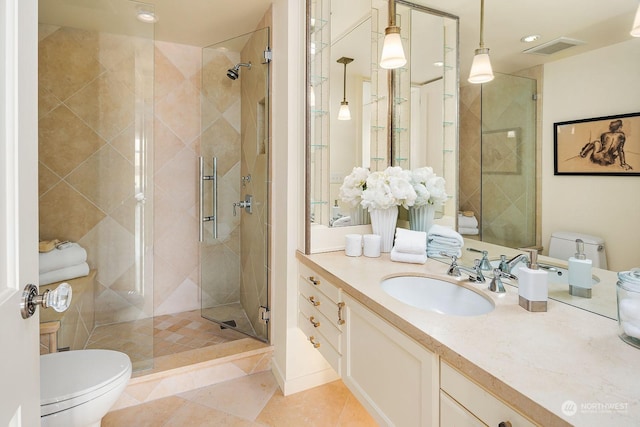 bathroom featuring vanity, tile patterned floors, toilet, and walk in shower