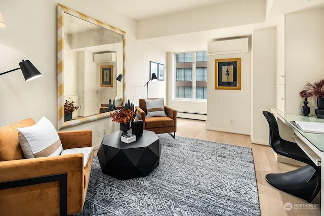 sitting room with light hardwood / wood-style flooring, a baseboard radiator, and a wall unit AC