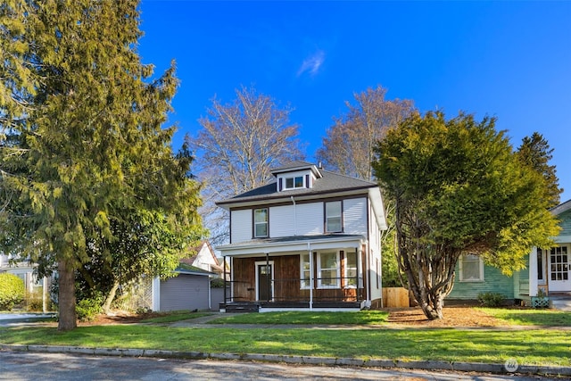 view of front of home featuring covered porch and a front lawn