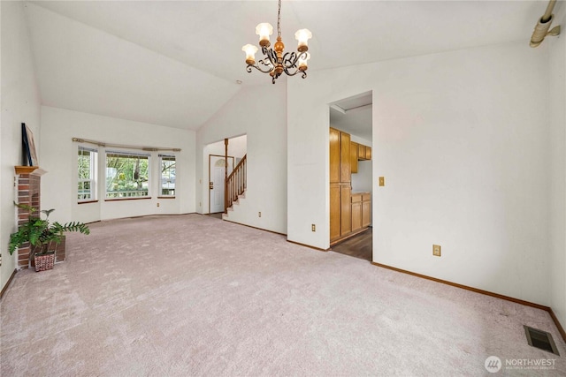 unfurnished living room featuring visible vents, baseboards, vaulted ceiling, stairway, and carpet