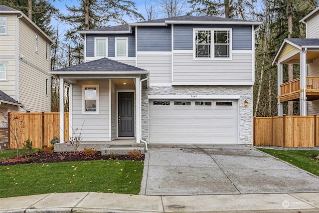 view of front of property featuring a garage and a front yard