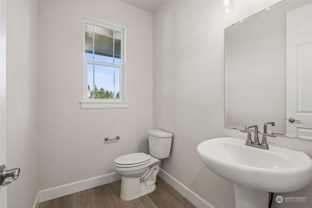 bathroom with sink, hardwood / wood-style flooring, and toilet