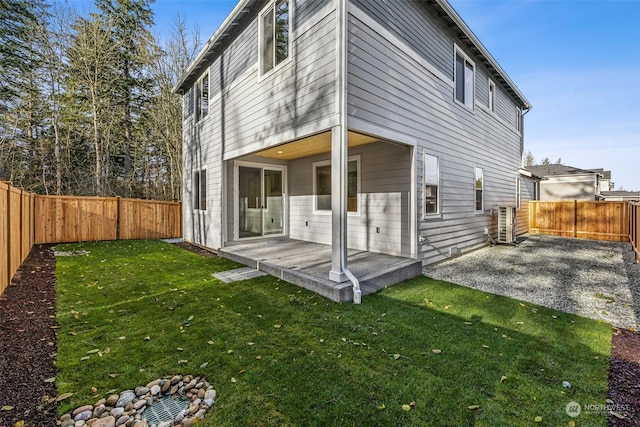 rear view of house with a patio and a lawn