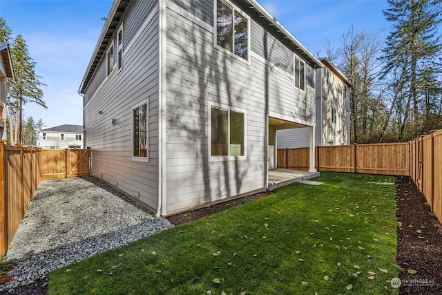 rear view of property featuring a yard and a patio area