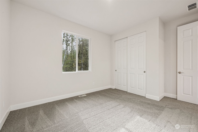 unfurnished bedroom with a closet and carpet