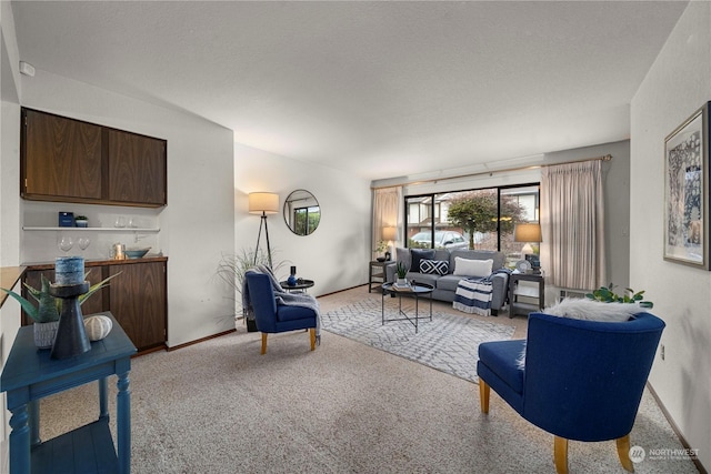 living room with a textured ceiling and carpet flooring