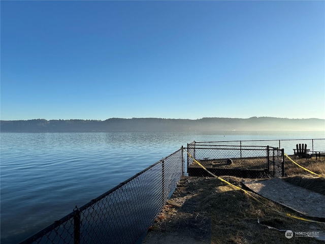 view of dock featuring a water and mountain view