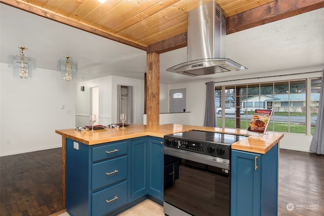 kitchen featuring range with electric stovetop, butcher block counters, exhaust hood, and blue cabinets