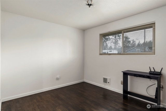 unfurnished office with dark wood-type flooring