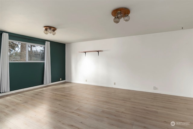 empty room with light hardwood / wood-style flooring